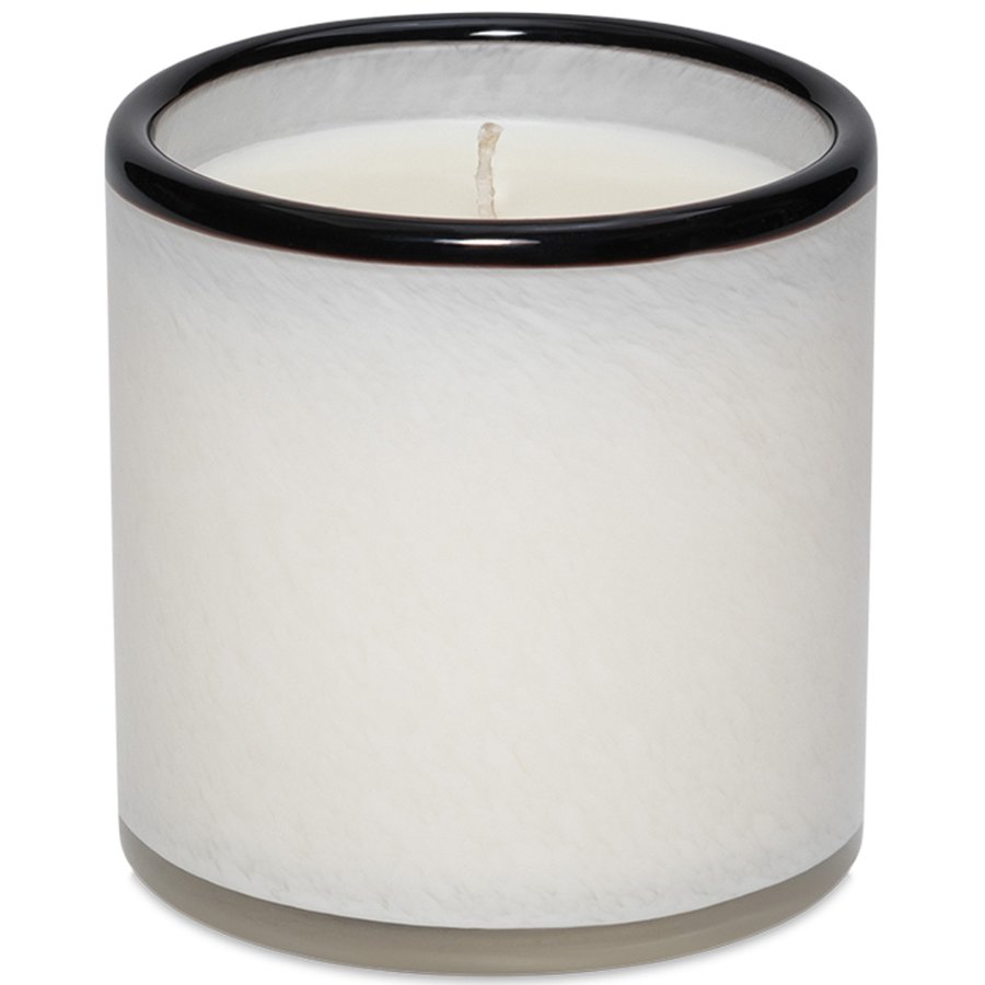 White candle in a marble-textured holder with black rim on a white background