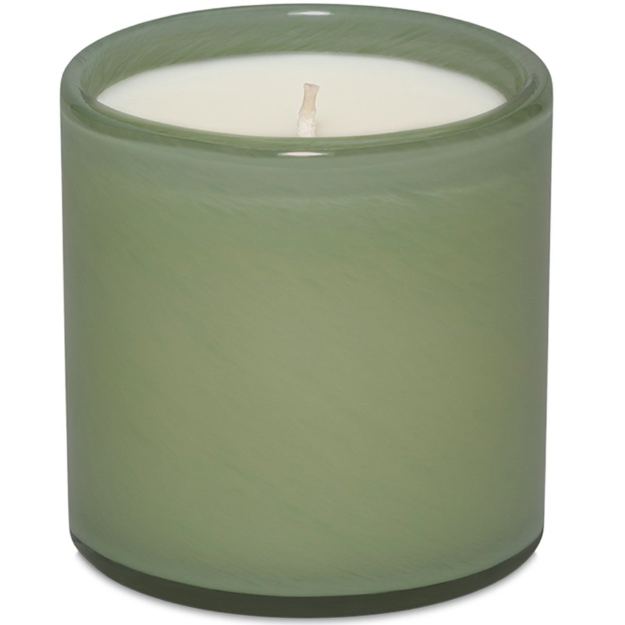 Green candle in a glass container on a white background