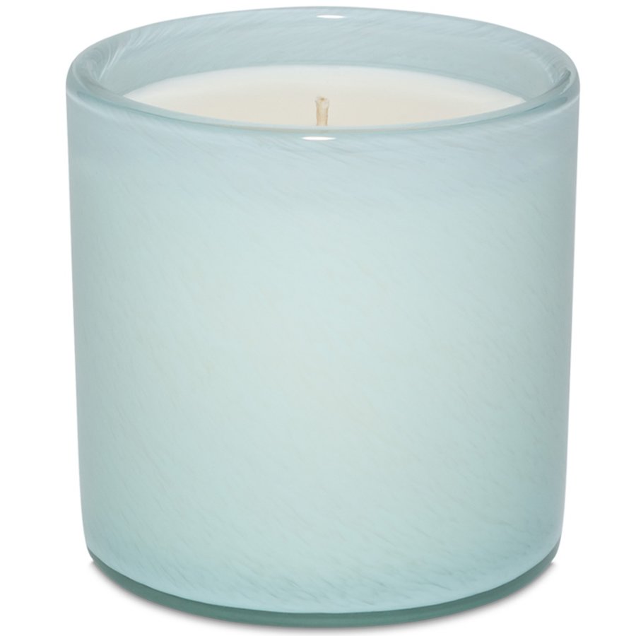 Candle in a light blue glass container on a white background