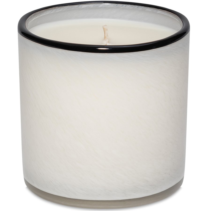 White candle in a glass container with a black rim on a white background