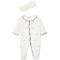 Baby onesie with black trim and matching headband on a white background