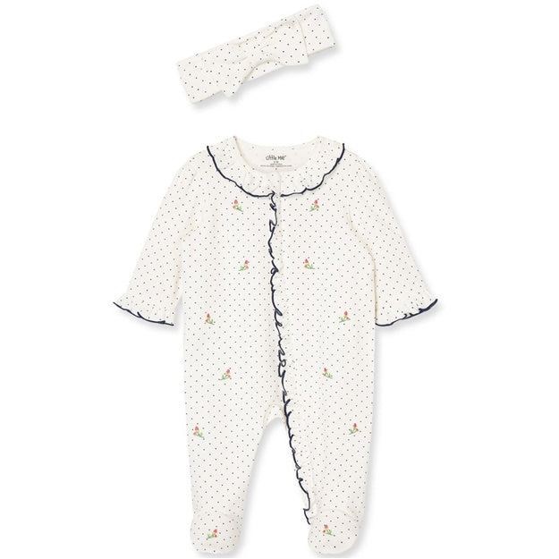 Baby onesie with black trim and matching headband on a white background