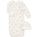 Pink baby gown with matching hat on a white background