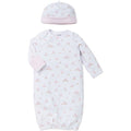 Baby gown and hat set with pink and white pattern on a white background