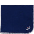 Navy blue blanket with sailboat designs on a white background