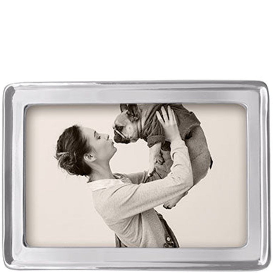 Rectangular photo frame with a black and white photo of a woman holding a dog inside.