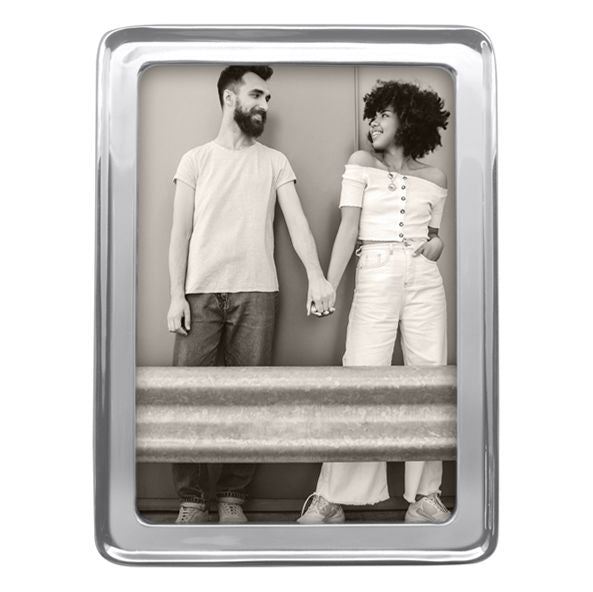 Silver photo frame with a black and white photo of two people holding hands.