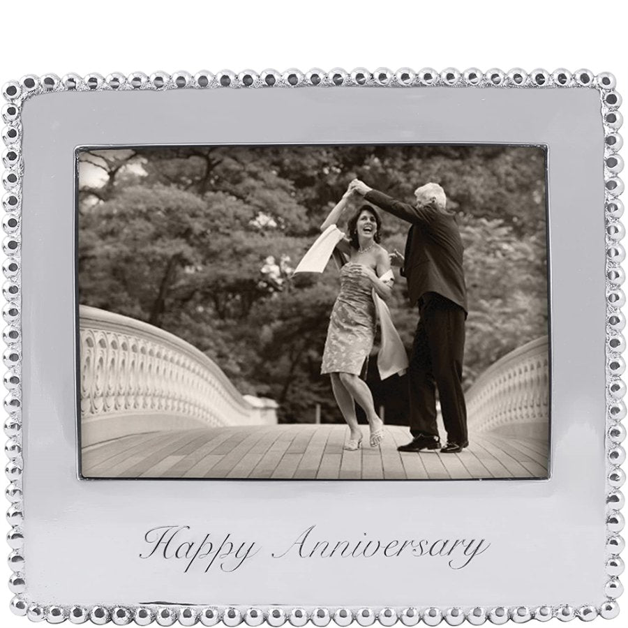 Decorative silver frame with 'Happy Anniversary' text, containing a black and white photo of a couple dancing.