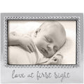 Baby sleeping in a decorative frame with 'Love at First Sight' text