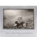 Silver photo frame with 'You are my sunshine' text, containing a black and white photo of a child in a field.