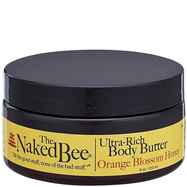 Jar of The Naked Bee Ultra-Rich Body Butter with black lid and yellow label on a white background