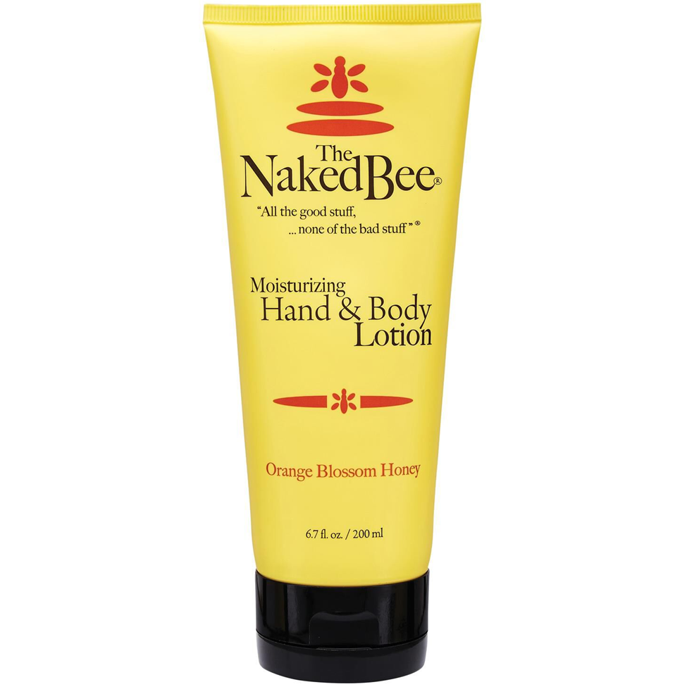 Yellow tube of Naked Bee moisturizing hand and body lotion on a white background
