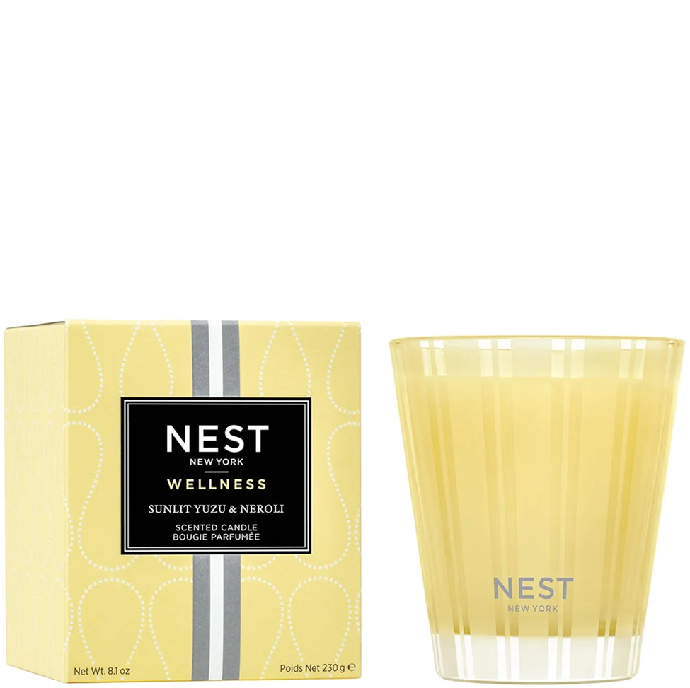 Yellow NEST candle and packaging on a white background