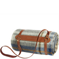 Roll-up picnic blanket with plaid pattern and brown leather strap on a white background
