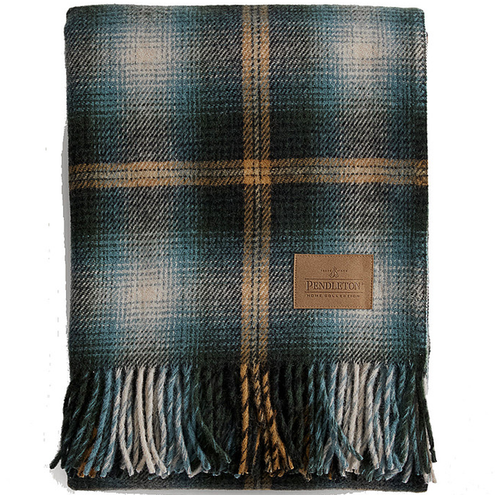 Plaid blanket with fringes and a Pendleton logo on a white background