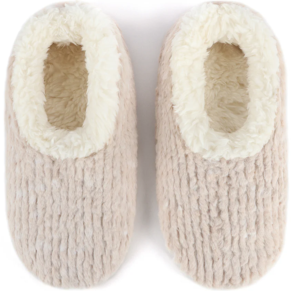 Pair of beige knitted slippers with white fuzzy lining on a white background