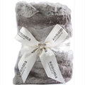 Gray plush blanket with a white ribbon and 'Sonoma Lavender Co.' branding on a white background