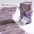 Packaged lavender products with a candle on a white background