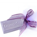 Lavender soap bar with a purple ribbon on a white background