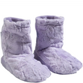 Pair of fluffy purple slippers on a white background