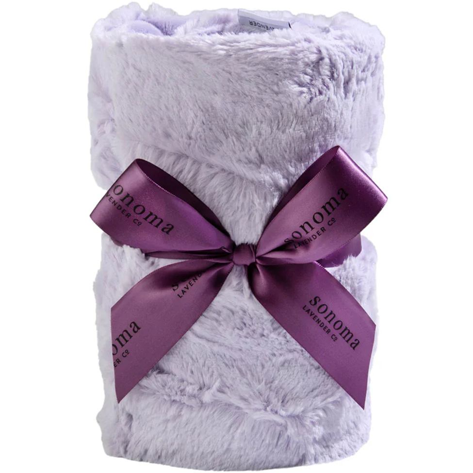 White plush blanket with a purple ribbon and 'Sonoma' branding on a white background