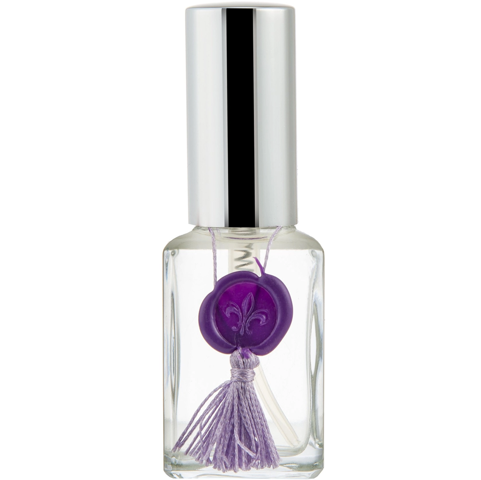 Small clear bottle with a silver cap and purple decorative element on a white background