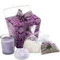 Lavender-themed gift set with a candle, soap, and lavender bag on a white background