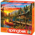 Springbok 1500 pc puzzle Scenic lakeside cabin with dock, red canoe, and colorful sunset.