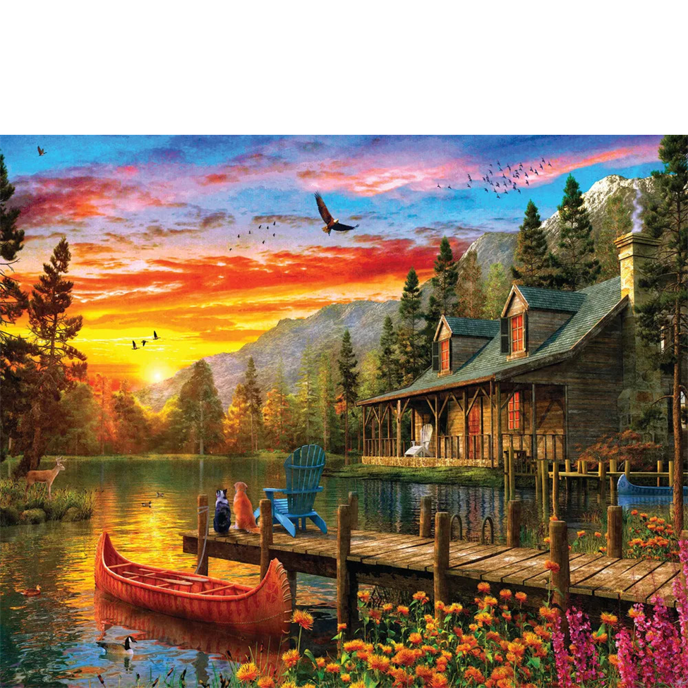 Scenic lakeside cabin with dock, red canoe, and colorful sunset.