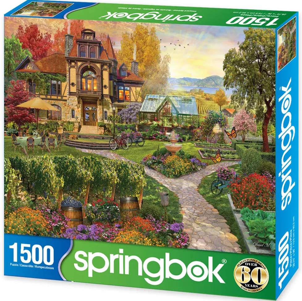 Springbok 1500-piece puzzle box with a scenic garden and house illustration.
