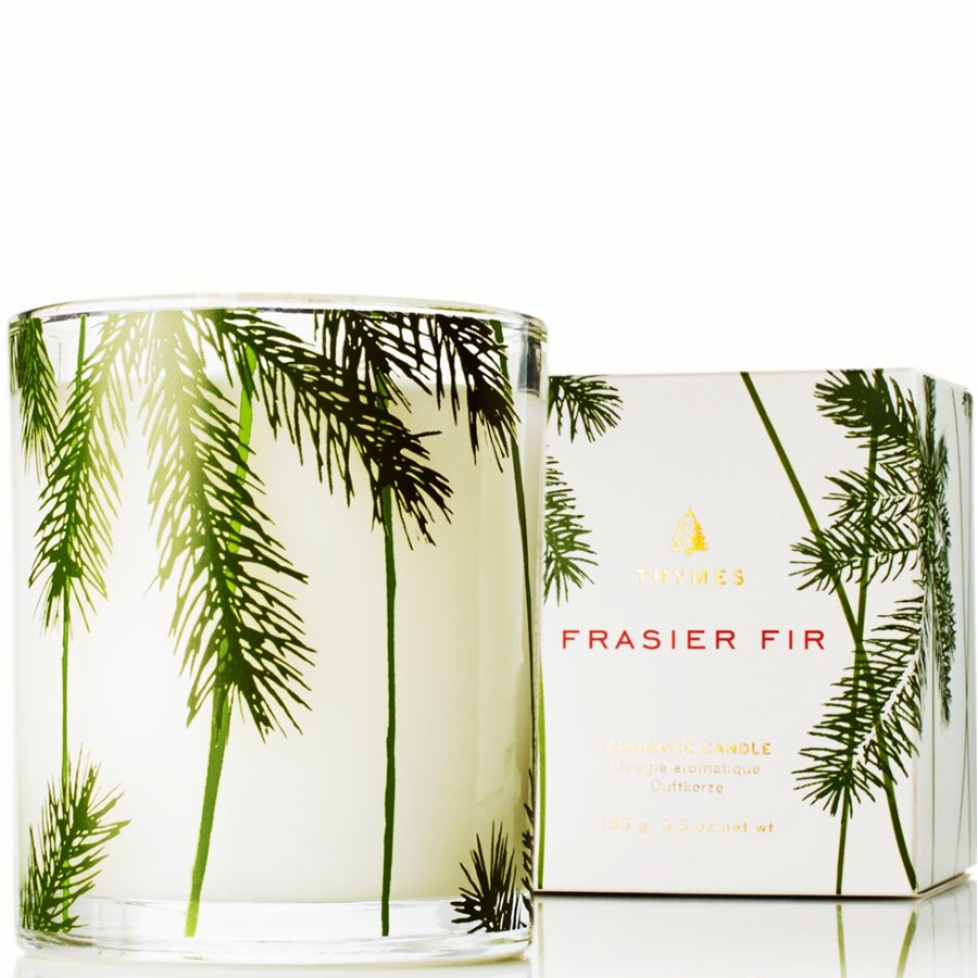 Frisier Fir candle with packaging featuring palm tree design on a white background
