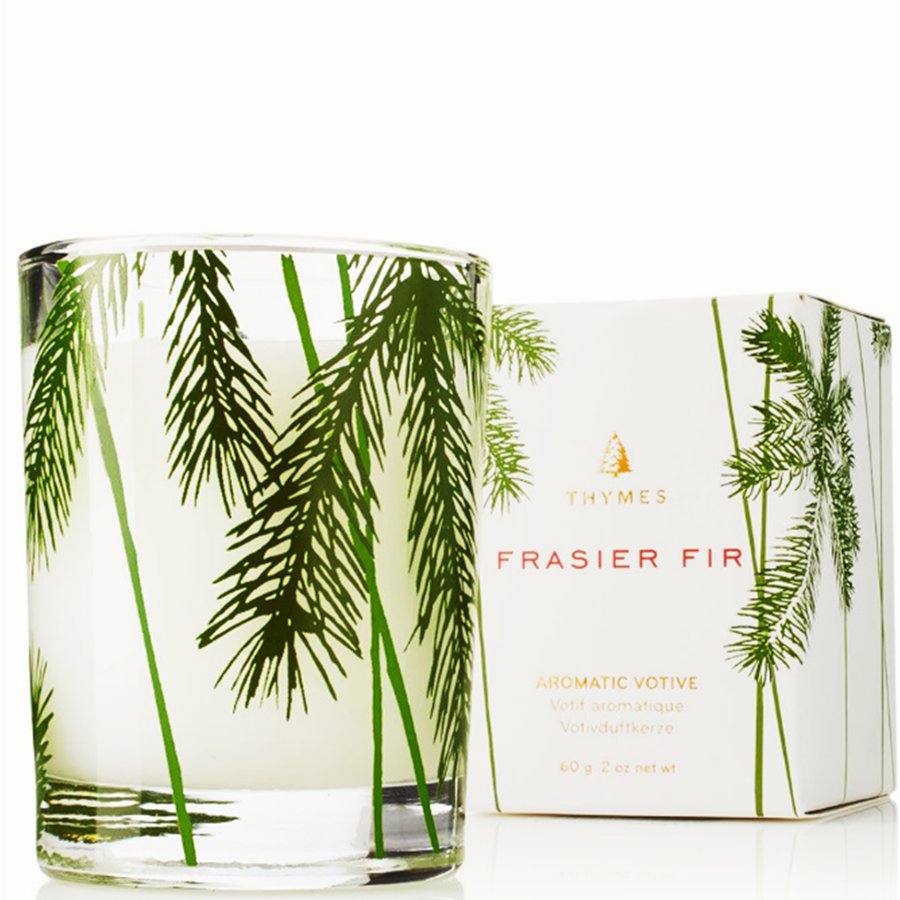 Thymes Frasier Fir candle with green leaf design on a white background
