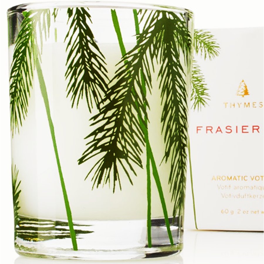 Candle with palm leaf design and Thymes Frasier candle packaging in the background