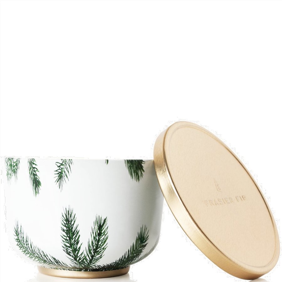 Ceramic container with green leaf pattern and gold lid on a white background