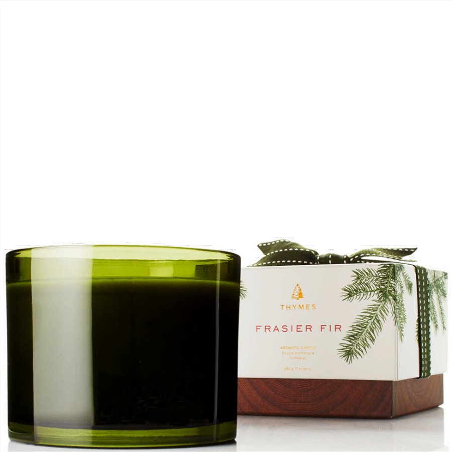 Green candle with a Thymes Frasier Fir box on a white background