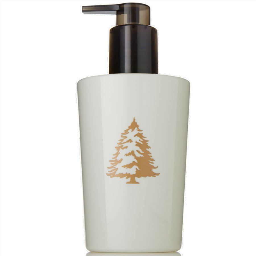 White soap dispenser with gold tree design on a white background