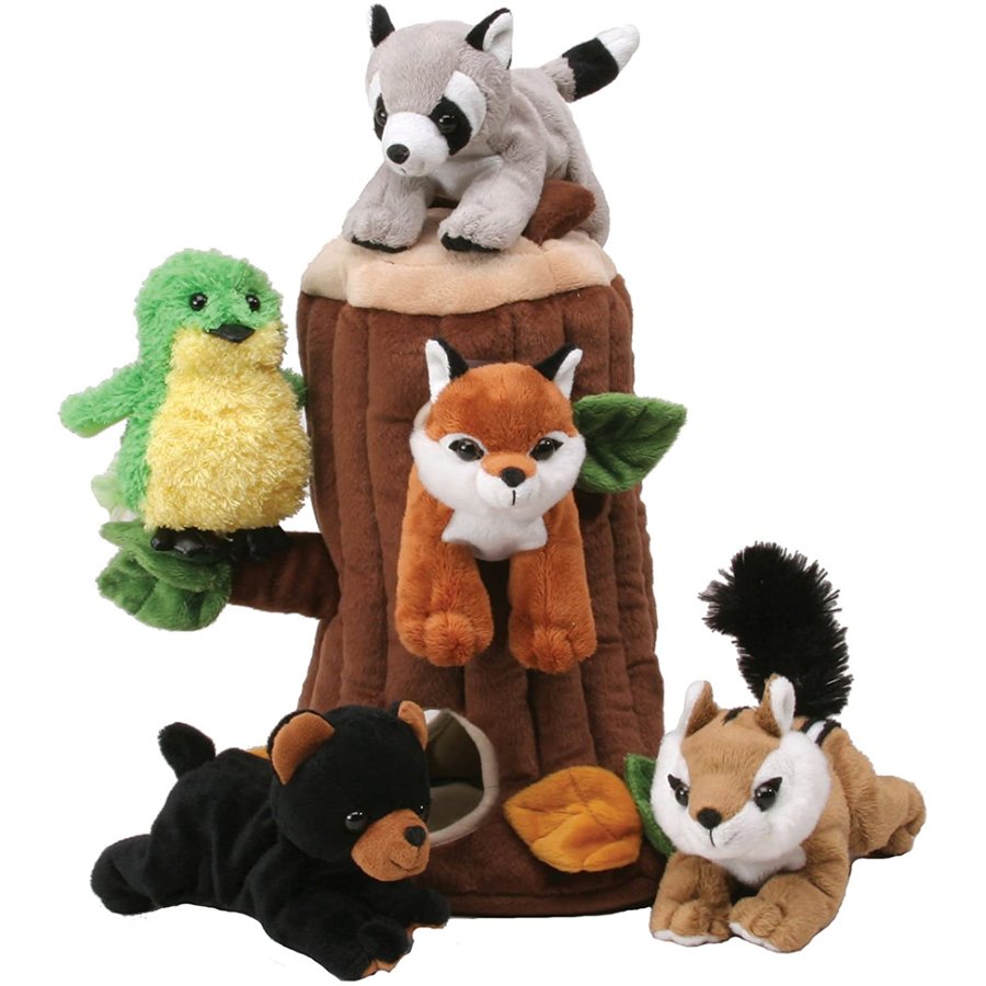 Set of plush forest animals including a raccoon, frog, fox, and chipmunk on a tree stump.