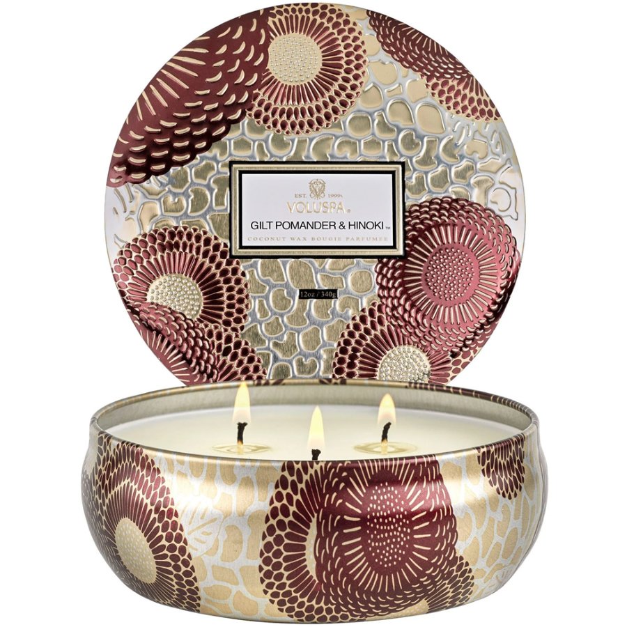 Decorative candle in a tin with floral pattern and Yolkin branding.