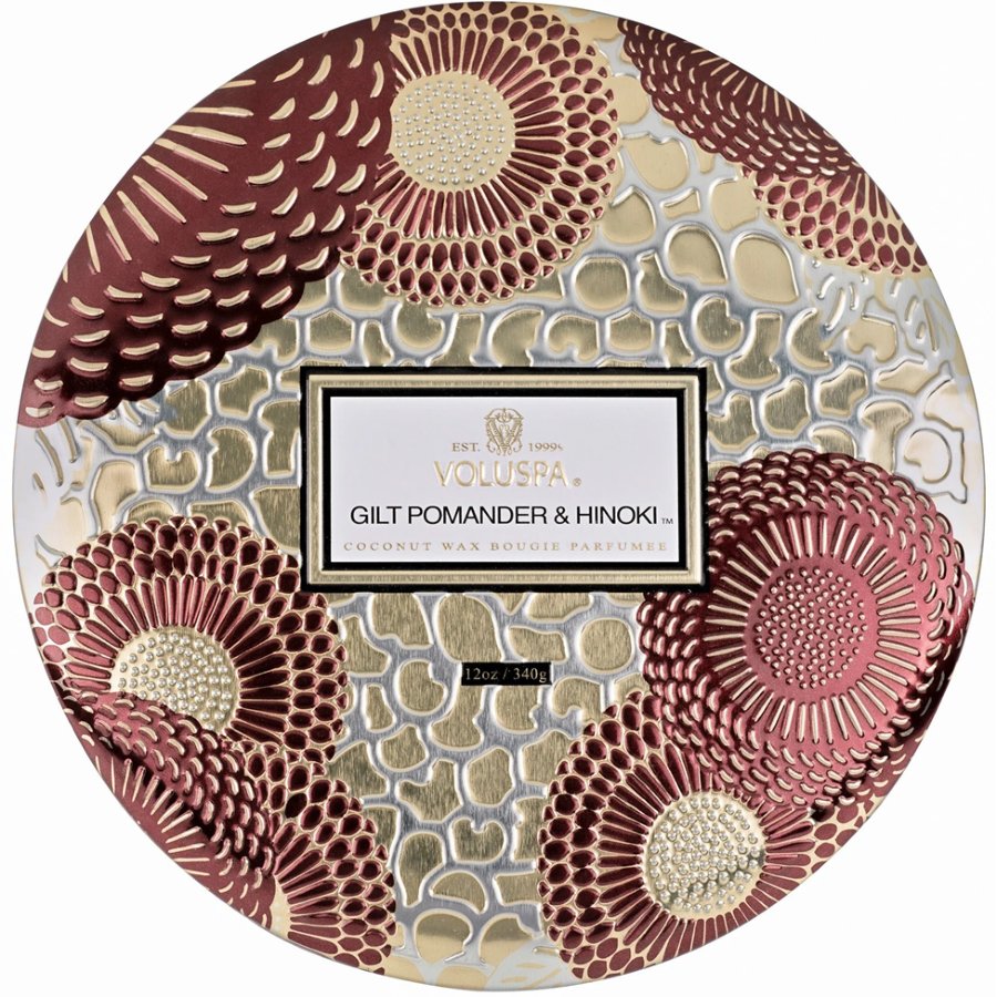 Decorative pomander with floral patterns and Voluspa branding on a white background