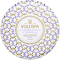 Decorative Voluspa candle packaging with intricate patterns and branding.