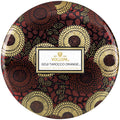Decorative container with Voluspa branding and a floral pattern on a white background