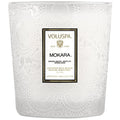 White textured candle with Voluspa Mokara label on a white background