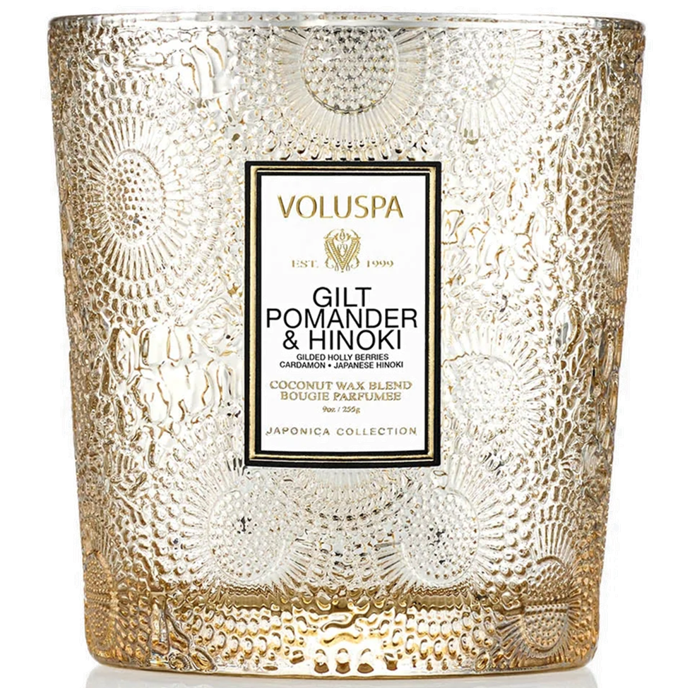 Decorative candle with textured glass and Voluspa branding on a white background