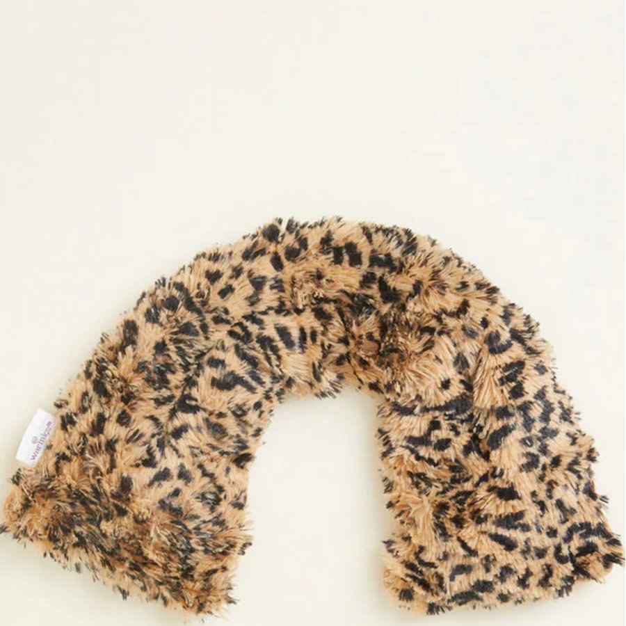 Leopard print neck pillow on a white background