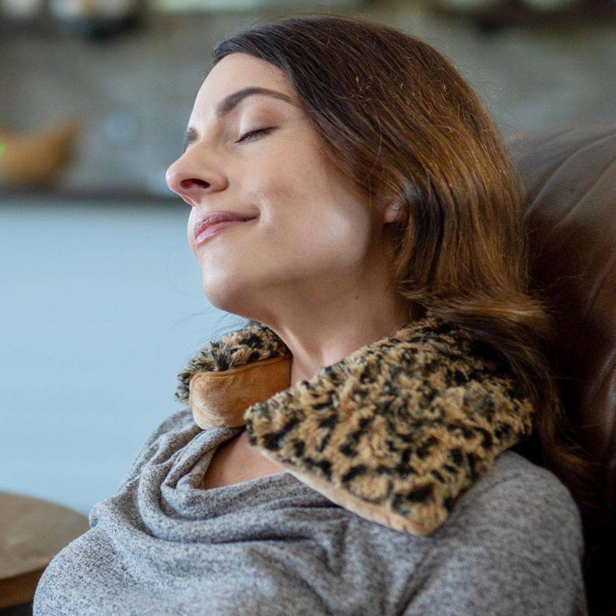 Woman wearing a leopard print neck pillow in a casual setting