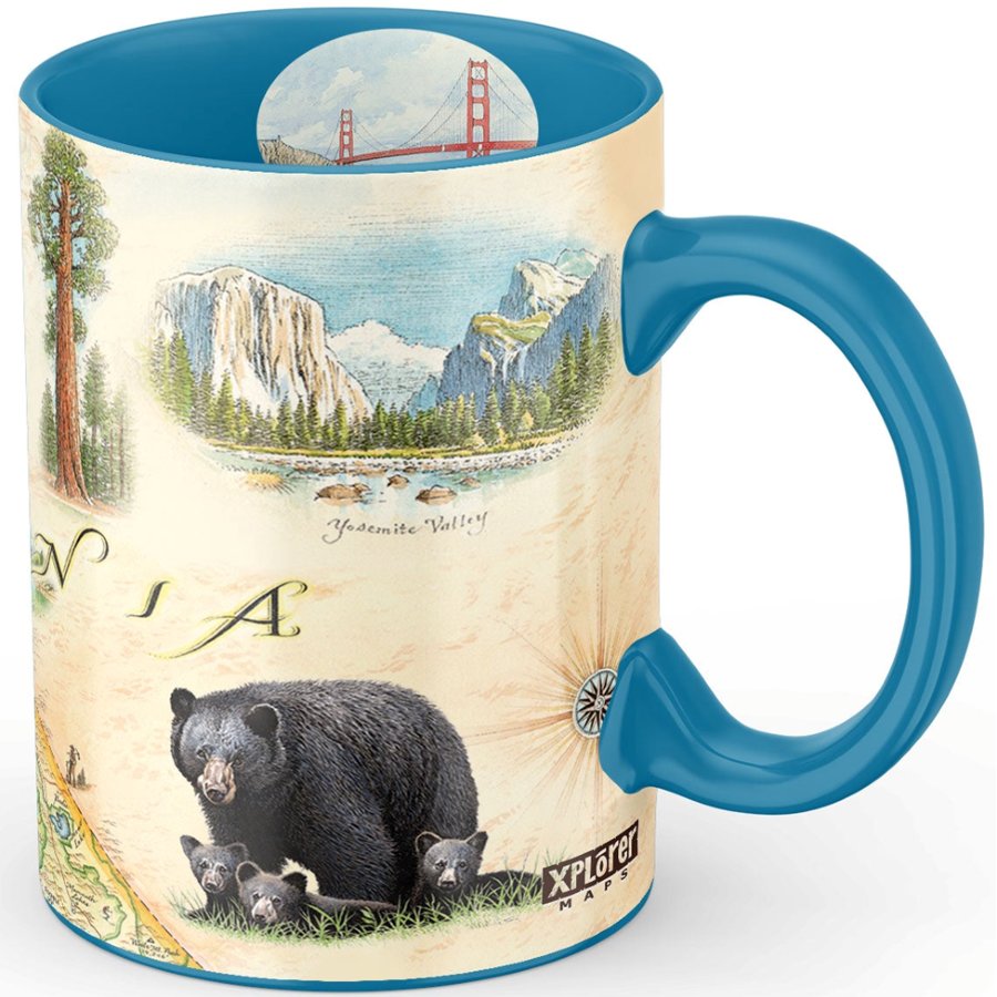 Mug with scenic design of mountains, bear, and trees with blue interior and handle.