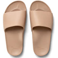 Pair of beige slides on a white background