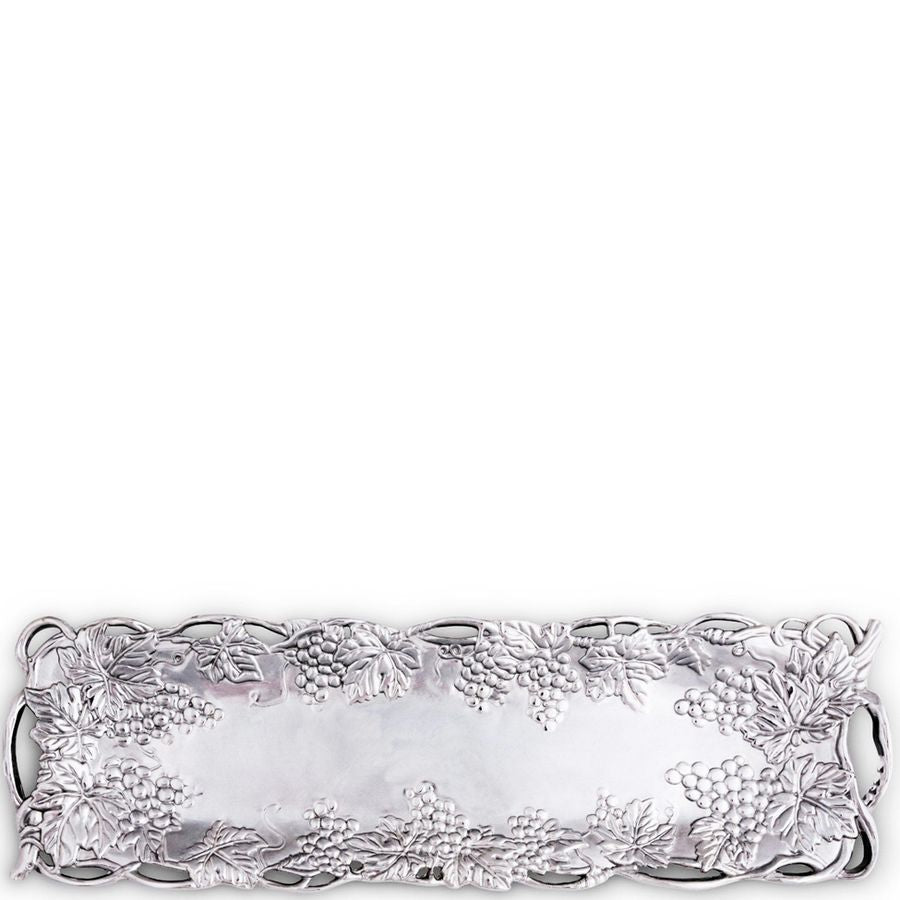 Decorative silver tray with intricate designs on a white background