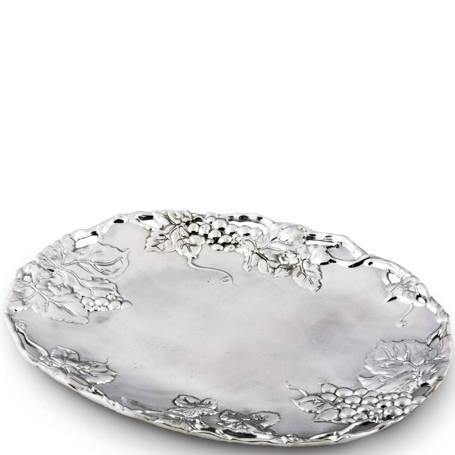 Decorative silver tray with floral patterns on a white background