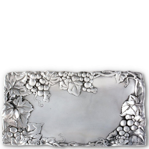 Decorative silver belt buckle with grapevine design on a white background